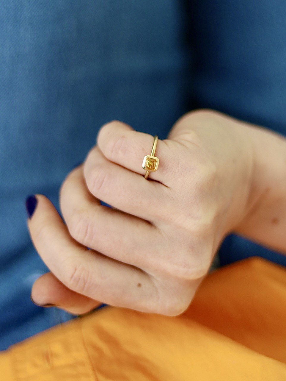 a ring with a yellow gemstone
