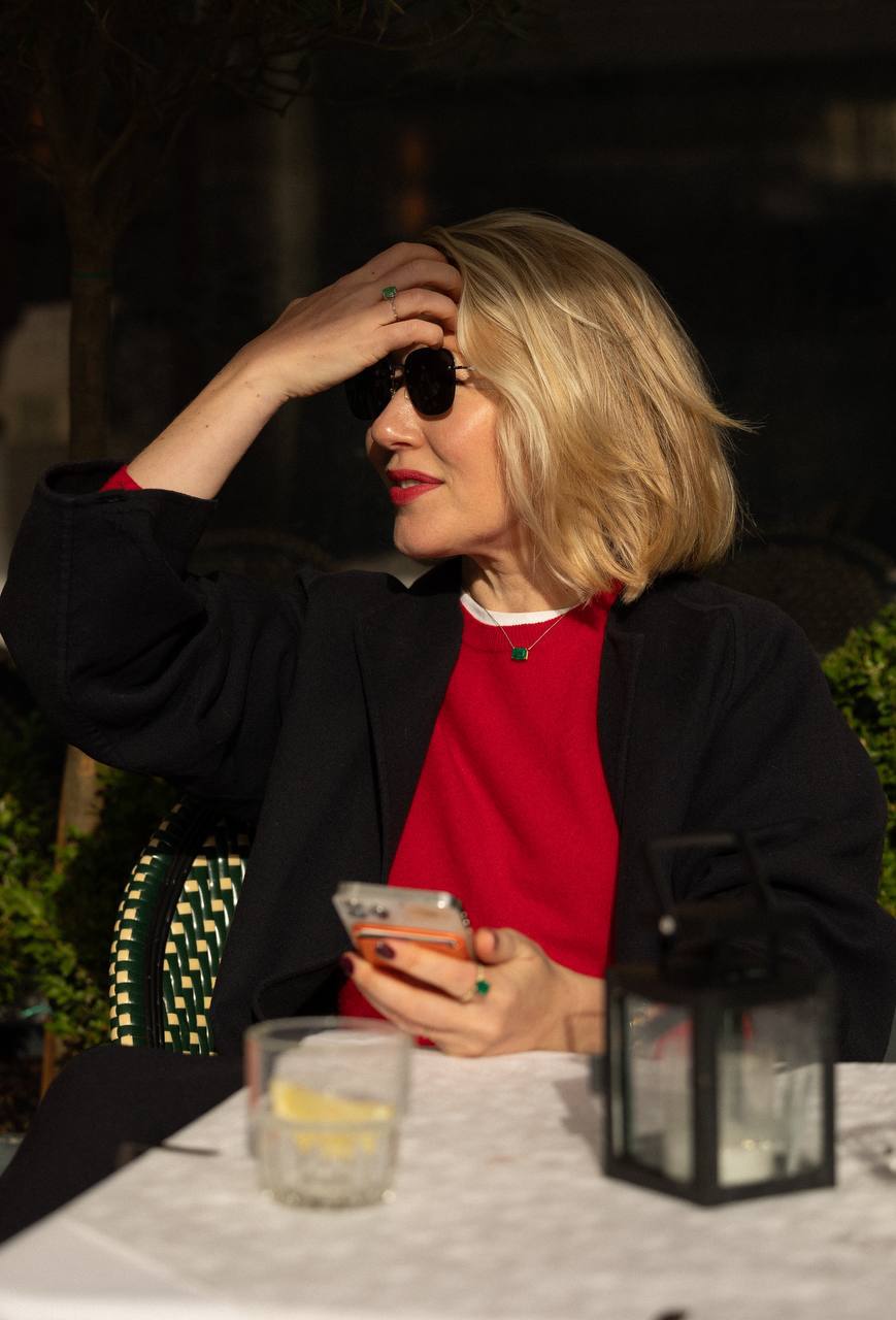 a woman sitting on the chair and touch her hair