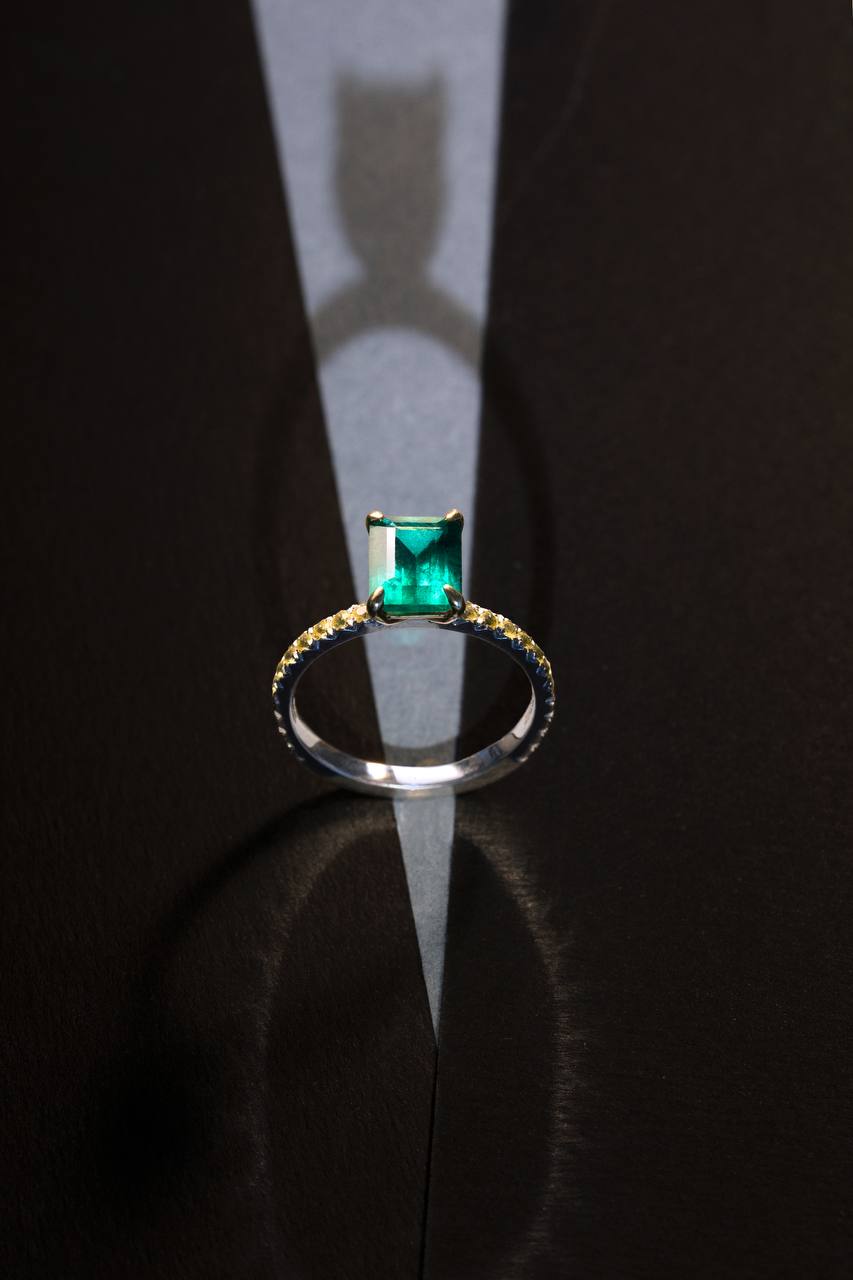 a ring with a green gemstone