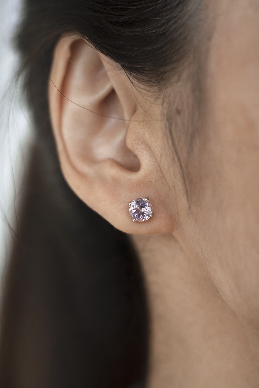 a stud with a pink gemstone in the ear