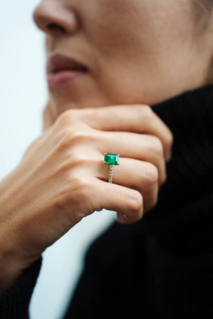 a ring with a green gemstone